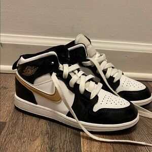 Nike Black and Gold High-Top Jordan’s